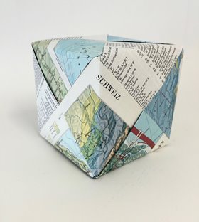 Jennifer Cochrane, Swiss World Atlas Cube, 2016. Dock Under. Paper from Swiss World Atlas books. 10x10x10cm. Image courtesy of the artist.