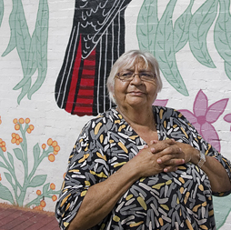 Printmaker Laurel Nannup stands in front of the mural she designed in Northbridge. Image: Christophe Canato 